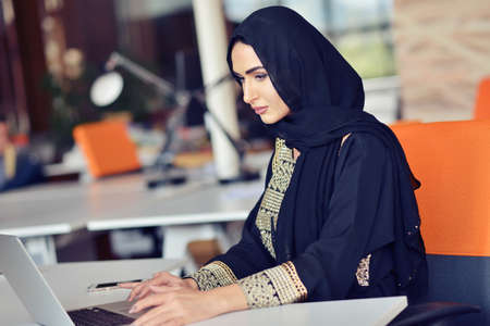 Muslim asian woman working in office with laptopの写真素材