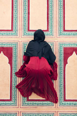 Top aerial view Young beautiful Muslim Woman Praying In Mosqueの写真素材