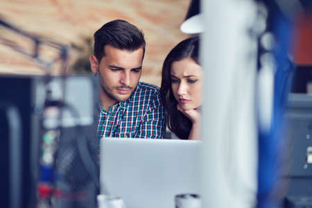 Young Casual business couple using computer in the office. Coworking, Creative manager showing new...