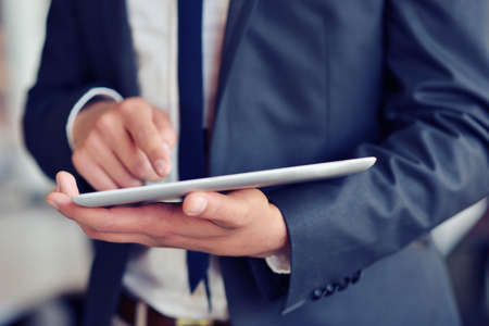 businessman holding digital tablet in officeの写真素材