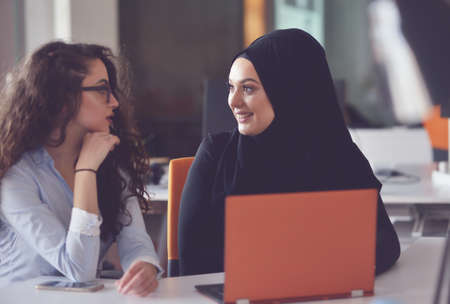 Two Muslim business woman working on their laptop.の写真素材