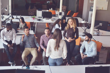 business, startup, presentation, strategy and people concept - female on presentation with group of people at officeの写真素材