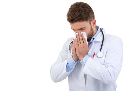 Doctor sneezing isolated against white background