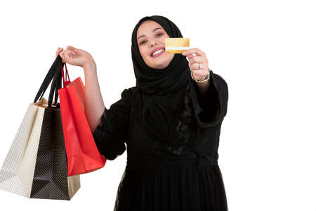 Happy of standing muslim woman with shopping bag and credit card isolated over white background
