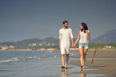 Young happy couple on white beach at summer vacationの写真素材