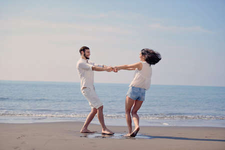 happy young romantic couple in love have fun on beautiful beach at beautiful summer day.の写真素材