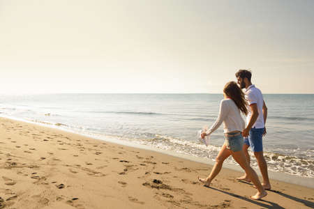 Young happy couple on seashore. Male has beard.の写真素材
