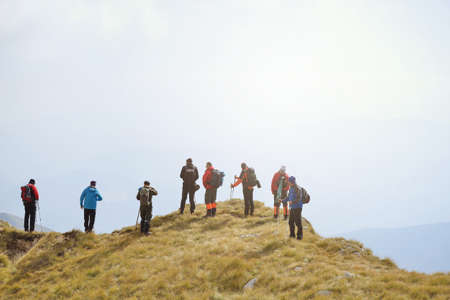 Group of tourists with backpacks on a mountain trail