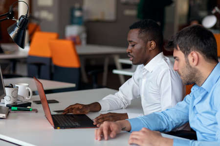 Two smart businessman using smartphone and laptop workig in office.の写真素材