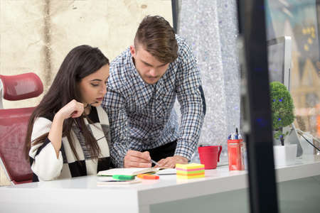 business couple working together on project at modern startup officeの写真素材