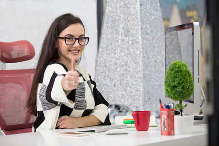 Side view of a satisfied entrepreneur with a new job at officeの写真素材