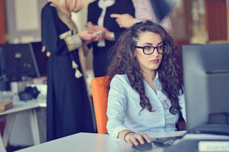 Young Arabic business woman wearing hijab,working in her startup office. Diversity, multiracial conceptの写真素材