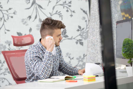 business, people, stress, emotions and fail concept - angry businessman throwing papers in officeの写真素材