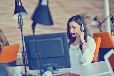 Woman working at computer in an officeの写真素材
