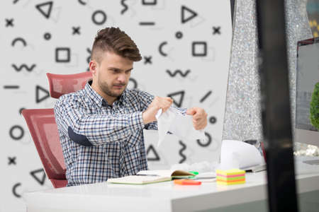 business, people, stress, emotions and fail concept - angry businessman throwing papers in officeの写真素材