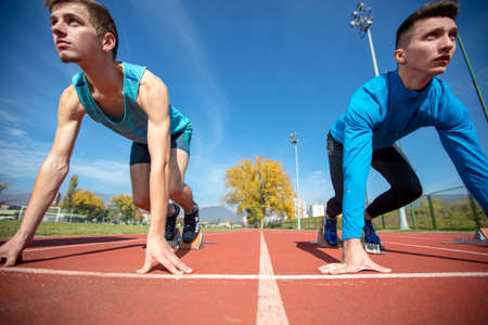 Athletes at the sprint start line in track and fieldの写真素材