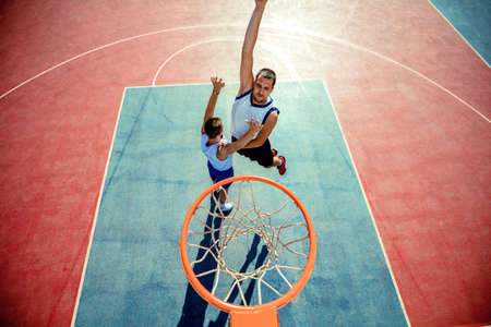 High angle view of basketball player dunking basketball in hoop
