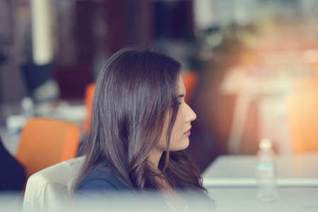 Image of woman using laptop while sitting at her desk.の写真素材