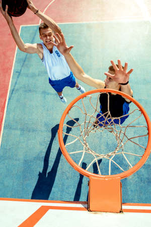 High angle view of basketball player dunking basketball in hoop