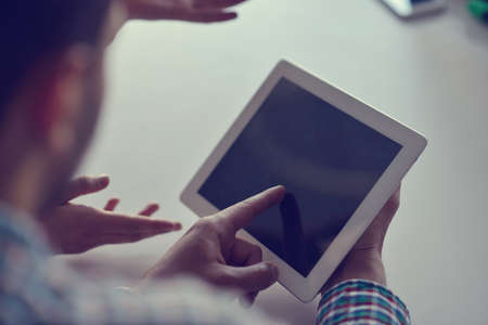 Midsection of businessman using digital tablet in officeの写真素材