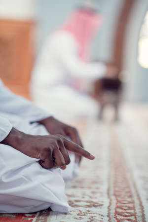 African Muslim Man Making Traditional Prayer To God While Wearing Dishdashaの写真素材