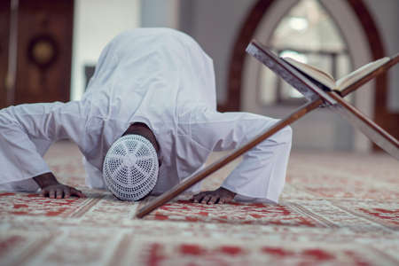 African Muslim Man Making Traditional Prayer To God While Wearing Dishdashaの写真素材