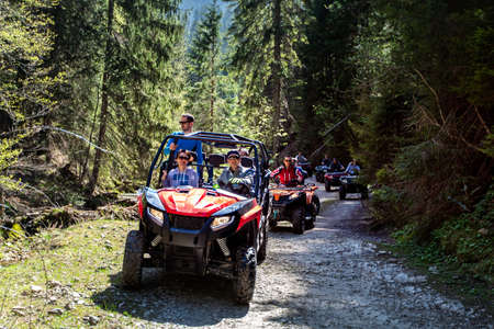 A tour group travels on ATVs and UTVs on the mountainsの写真素材