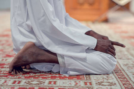 Two religious muslim man praying together inside the mosque.の写真素材