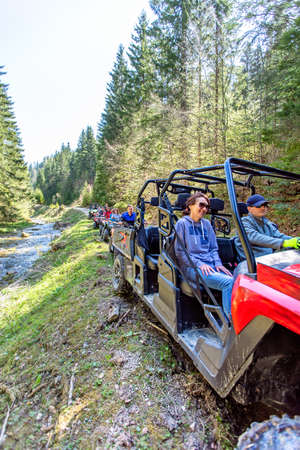 A tour group travels on ATVs and UTVs on the mountains