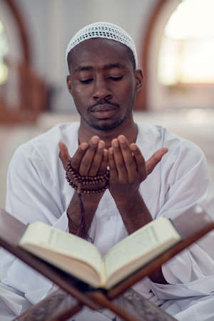 African Muslim Man Making Traditional Prayer To God While Wearing Dishdasha