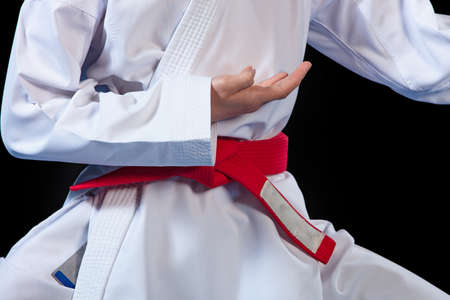 Aikido red belt on white kimono on black backgroundの写真素材