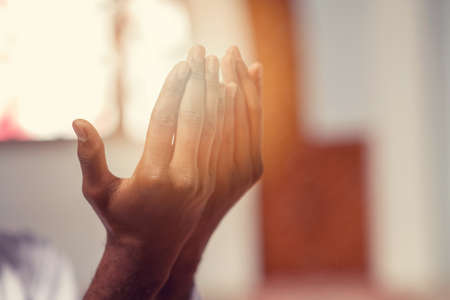 Hand of muslim black man people praying with mosque interior backgroundの写真素材