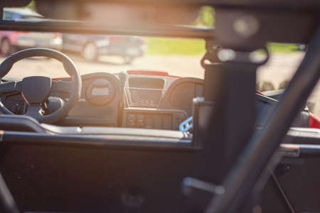 Young people on UTV vehicles on a countryside trail. View from a UTV vehicle with man driving an UTV on a sunny day.の写真素材