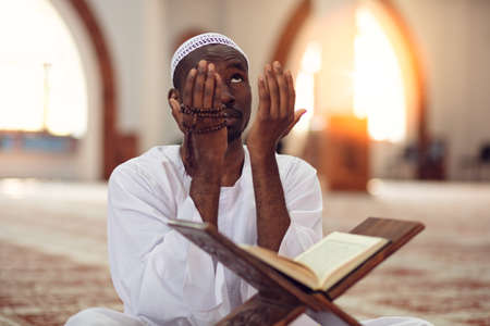 African Muslim Man Making Traditional Prayer To God While Wearing Dishdasha