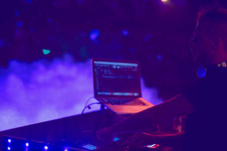 Dj mixes the track in the nightclub at party. DJ hands in motionの写真素材