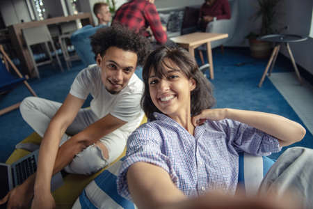 Group of happy smiling businesspeople making selfie and gesturing.の写真素材