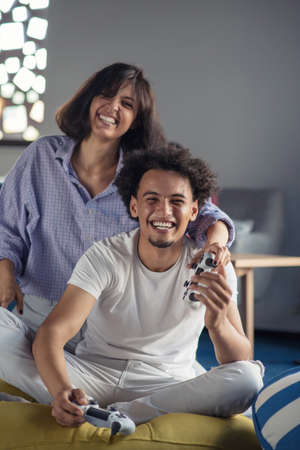 Happy couple playing video games at the modern startup office