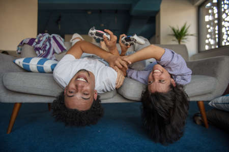 Young couple enjoying playing video games together.の写真素材