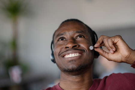 Emotional dark skinned male freelancer celebrating completed project successfully.