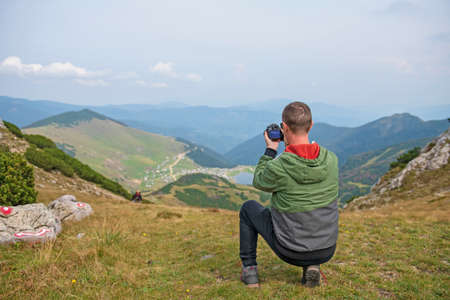 Male tourists are photographing a lake that is a natural attraction. Concept for Travel.の写真素材