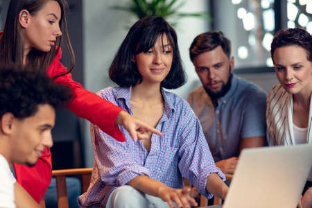 Teamwork concept.Young creative coworkers working with new startup project in modern office.Group of...