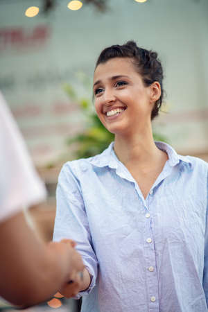 Digital technology and traveling. Young loving couple in casual wear using smartphone while standing in the airport terminal waiting for boarding.の写真素材