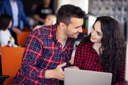 Happy business partners working on laptop. Teamwork, co-working concepts.