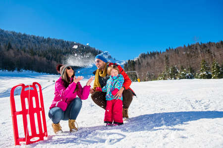 Happy Family In Snow Riding On Sledge.の写真素材