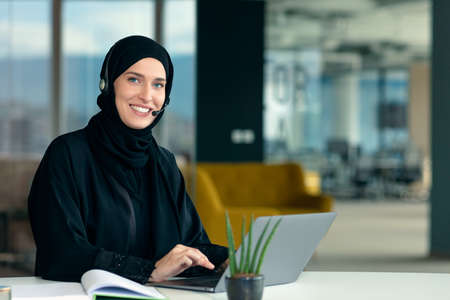professional young muslim business woman using mobile digital tablet computer at work