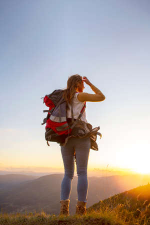 Portrait of happy young woman hiking in the mountainsの写真素材
