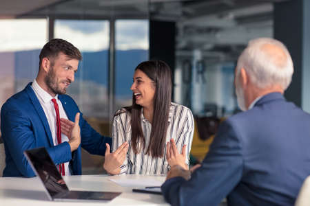 Positive aged couple consulting with insurance agentの写真素材