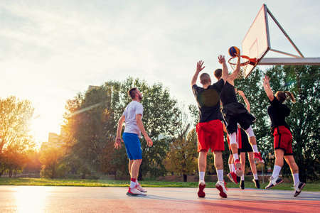 Group Of Young Friends Playing Basketball Matchの写真素材