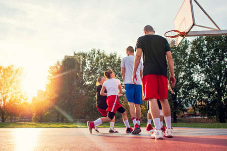 Group Of Young Friends Playing Basketball Matchの写真素材