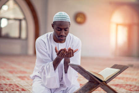 Religious black muslim man praying inside the mosqueの写真素材